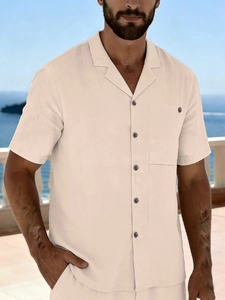 Detail of men's linen beach shirt showing Cuban collar and breast pocket in beige