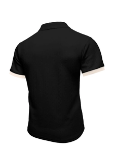 Rear view of black knit polo shirt featuring textured fabric and cream sleeve trim accents