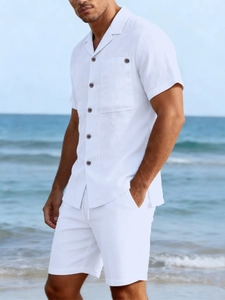 Detailed texture of white linen shirt with wooden buttons and drawstring waist shorts