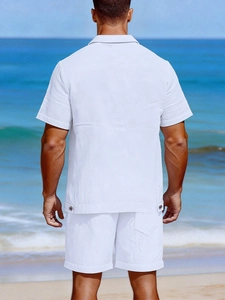 Detail of white seersucker summer set for men against a beach and blue sky background