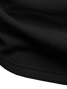 Detailed close-up of black honeycomb textured knit fabric with durable double-stitch hem