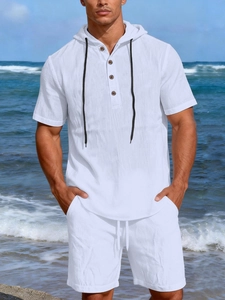 Detail of men's white linen textured summer set featuring waffle fabric and drawstring hood