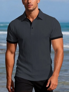 Detail of grey men's polo shirt with black contrast trim and textured vertical knit fabric