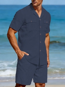 Detailed texture of navy linen men's casual shirt and shorts set in beach setting