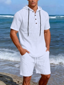 Close-up of white linen hooded henley and shorts set for men with textured fabric detail