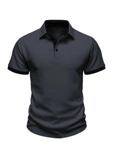 Macro detail of dark grey knit polo shirt with ribbed contrast collar and textured fabric