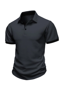 Detail of dark grey Polo shirt showing vertical wave texture and black ribbed cuffs