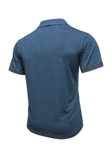 Detail view of the blue polo shirt showing brown contrast stitching on hem and sleeves