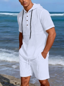 Detail of white linen summer set featuring textured fabric and contrasting black drawstrings