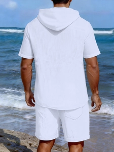 Detail view of white linen texture on men's summer hooded set with beach ocean background