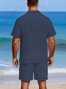 Detail view of navy linen set with textured fabric and adjustable buckle on shirt hem