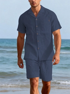 Detailed view of navy blue linen vacation set featuring a cuban collar and wooden buttons