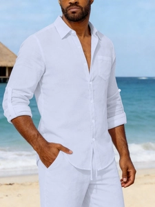 Detail of white linen shirt showing the breathable fabric texture and chest pocket detail