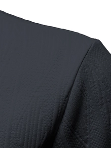 Macro shot of dark grey waffle knit fabric texture and shoulder seam on polo shirt