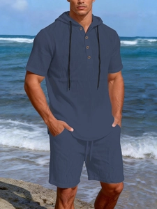 Detail of navy linen summer set for men featuring a hooded shirt and drawstring shorts