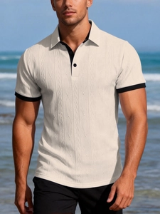 Close-up of cream knit polo shirt featuring textured cable patterns and black contrast trims