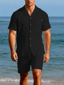 Close-up of black linen summer set featuring textured short-sleeved shirt and casual shorts