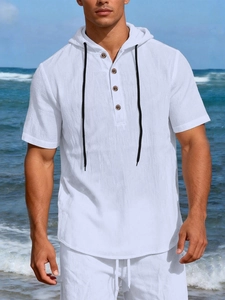Detail of white linen beach set for men featuring a hooded henley collar and buttons