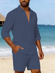 Detail of men linen two-piece set featuring long sleeve shirt with pocket and beach shorts