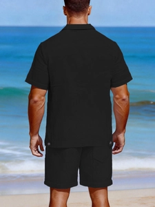 Rear view of men's black linen vacation set featuring breathable textured fabric on a beach