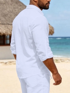 Detailed texture of white linen beach shirt showing breathable fabric and sleeve tabs