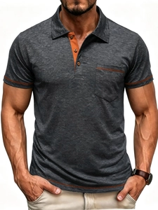 Detail of grey men's polo shirt with orange contrast stitching on pocket and sleeve