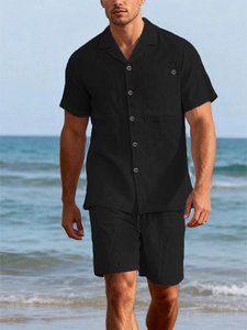 Detail of black linen summer set with short sleeve button-down shirt and casual shorts