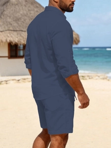 Detail of navy linen blend leisure set featuring roll-up sleeve buttons and beach styling