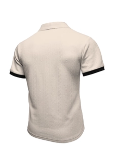 Detail of men's beige knit polo shirt featuring diamond jacquard texture and black ribbed cuffs