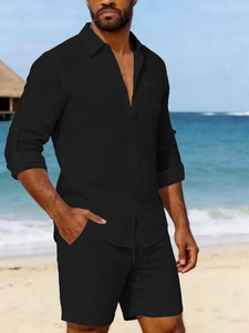 Close-up of men's black linen shirt with chest pocket and matching beach shorts