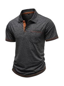 Detail of dark grey Polo shirt with orange contrast stitching and chest pocket macro