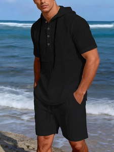 Detail of men's black linen beach set with drawstring hood and buttoned neckline