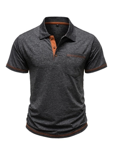 Detail of dark grey polo shirt showing breathable mesh fabric and orange stitching