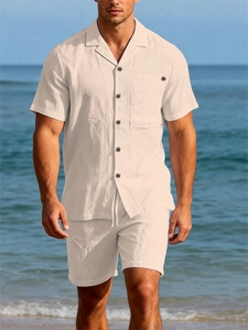 Close-up of off-white linen texture on a Cuban collar shirt with a chest pocket