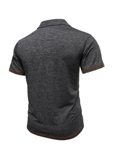 Rear view of dark grey polo shirt featuring contrast orange stitching on cuffs and hem