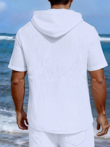Back view of men's white linen short-sleeved hoodie and shorts set at the beach
