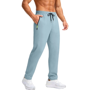 Detail of light blue sports joggers featuring elastic waist and zipper pockets