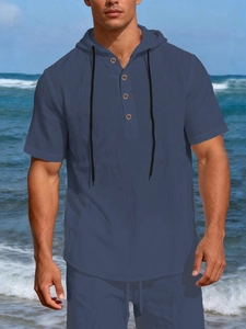Close-up of navy blue linen beach shirt featuring hood, drawstrings and button placket