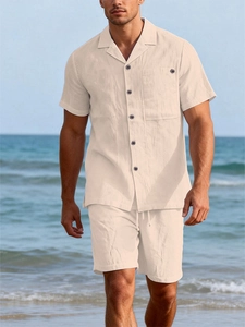 Detail of light beige linen shirt texture with dark buttons and matching drawstring shorts