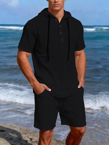 Close-up of black men's linen short sleeve hooded shirt with drawstring and buttons