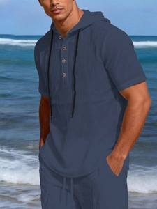 Detail view of navy linen beach set with drawstring hood and henley button neckline