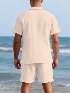 Rear view of beige linen short sleeve shirt and shorts set on a sunny beach landscape