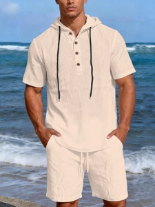 Detail of men's linen short sleeve hoodie and shorts set with textured fabric in beige