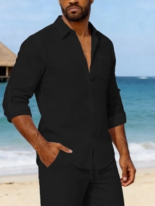 Detail of black linen beach shirt showing breathable fabric texture and pocket