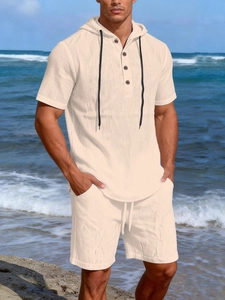 Detail of men's linen beach set featuring waffle texture hoodie and drawstring shorts
