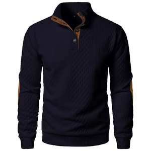 Detail of navy knit sweater featuring high neck collar with brown suede elbow patches