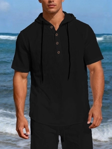 Detail of black linen beach hoodie featuring wooden buttons and natural fabric texture