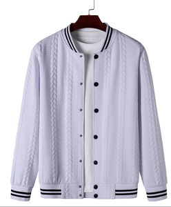 Detail of cable knit pattern and striped ribbed cuffs on men's baseball jacket