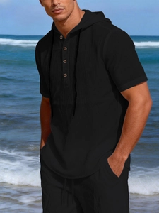 Detail view of black linen men's hooded henley set featuring button texture and beach style