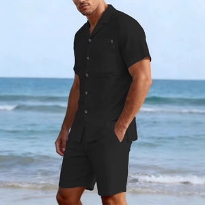 Men's black linen casual two-piece set with short sleeve shirt and shorts on beach